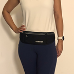 A person wearing a black Strivex waist bag with reflective trim