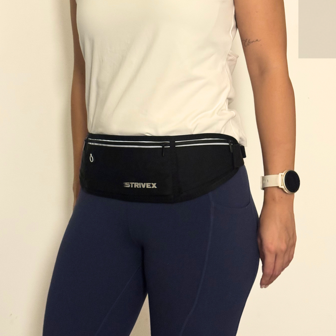A black Strivex waist pack running belt worn by a model in a white tank 