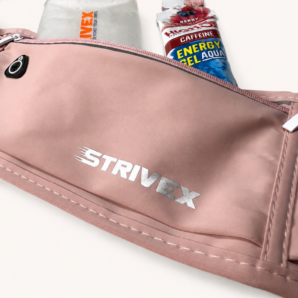 A close-up of a pink Strivex waist bag with a silver logo, showing its zippered compartments